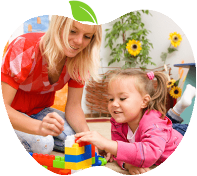Woman and young girl playing with colorful interlocking blocks on the floor, smiling during a game together.